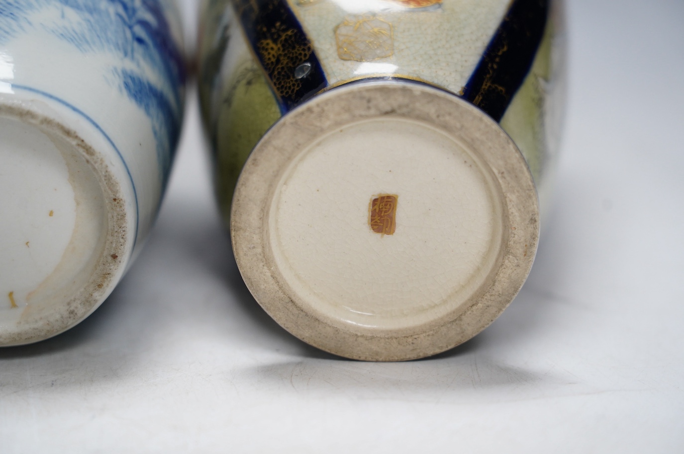 A pair of Japanese satsuma pottery vases and a blue and white Meiji Arita vase, largest 24cm high. Condition - fair